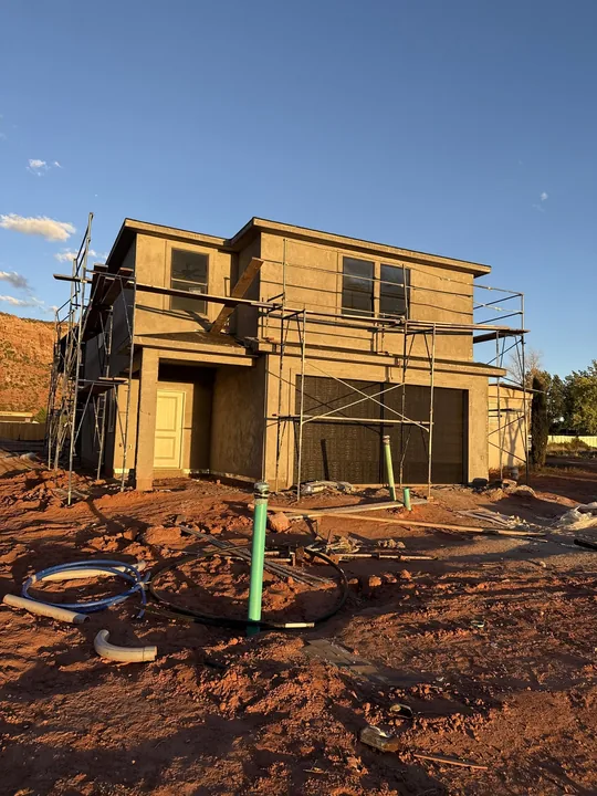 Two Story — Stucco base coat on scaffolds